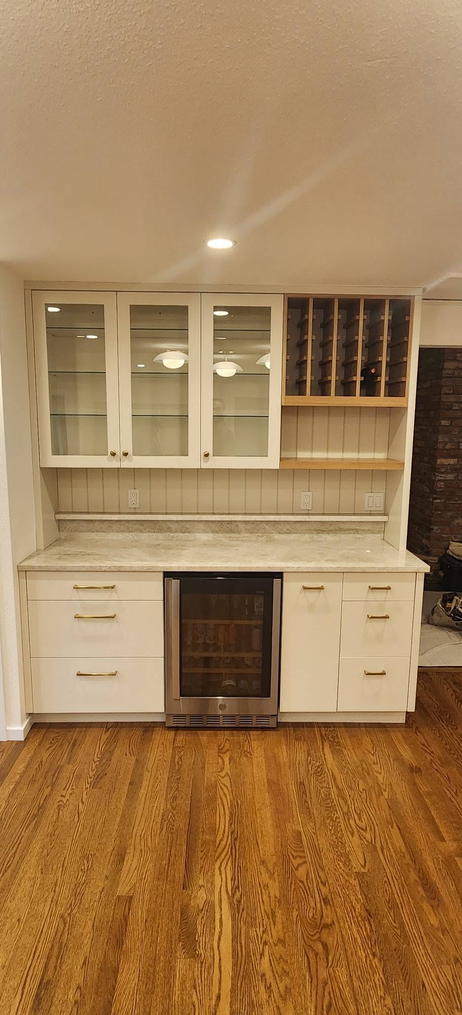 Custom bar hutch with glass doors, wine rack and marble counter