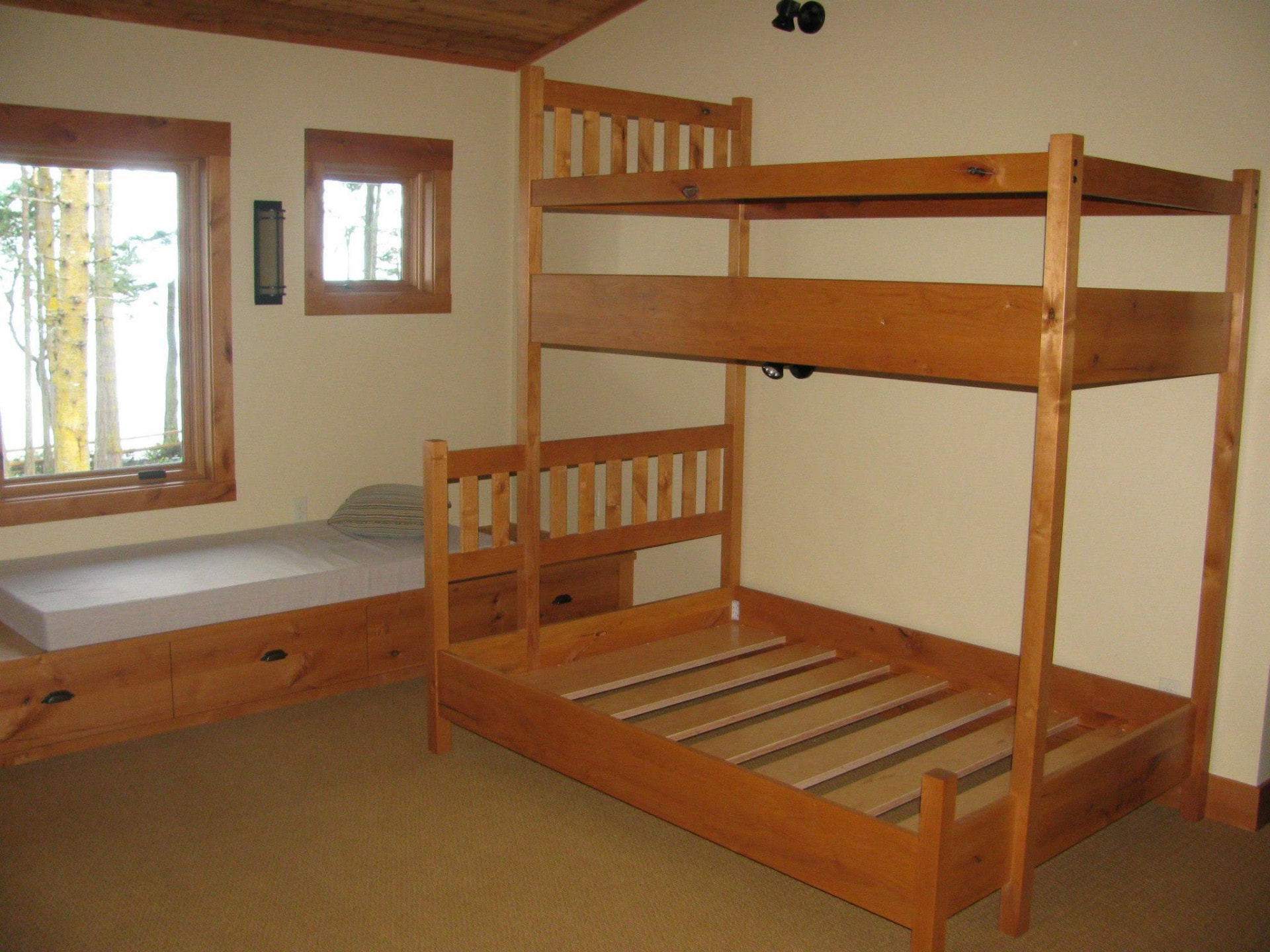 Custom built bunk beds and platform bed with drawer storage